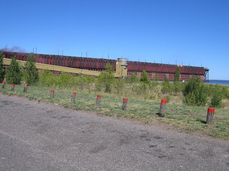 Note the train ore cars on top. The cars are placed ontop, the load is dumped into hoppers in the Dock. Then chutes are lowered into the ore carrier ships to lade the ore. 