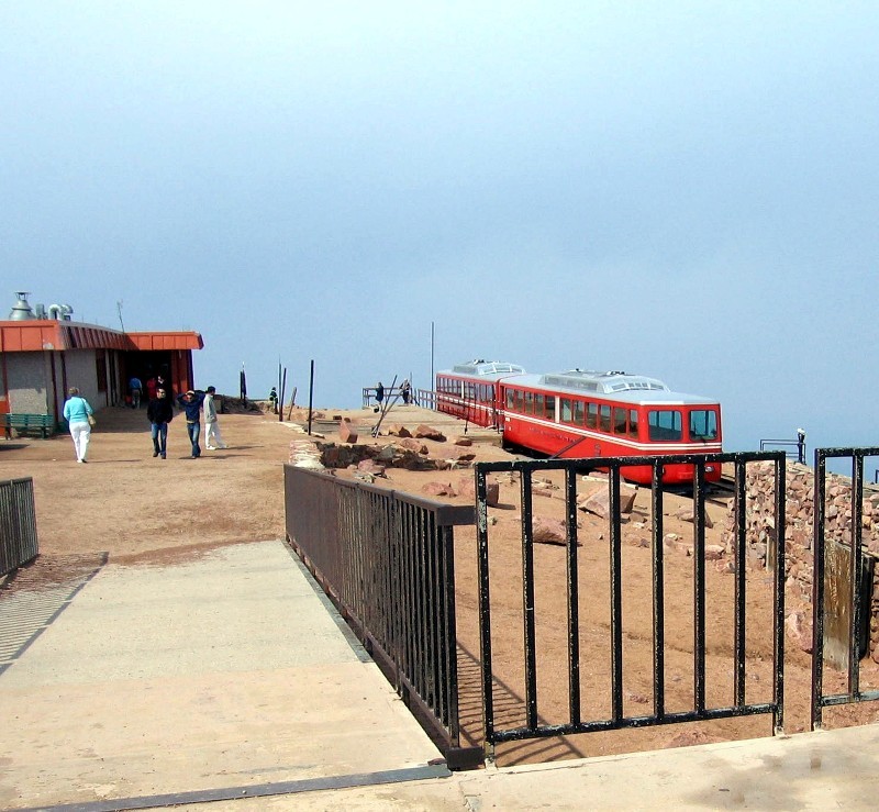 Interestingly, the summit is fairly flat. The train is parked next to the Summit House, visitors' center. <br/>In addition to reaching the summit via the cog train, over a half million people reach the summit house every year by the Pikes Peak Highway, and Barr Trail.